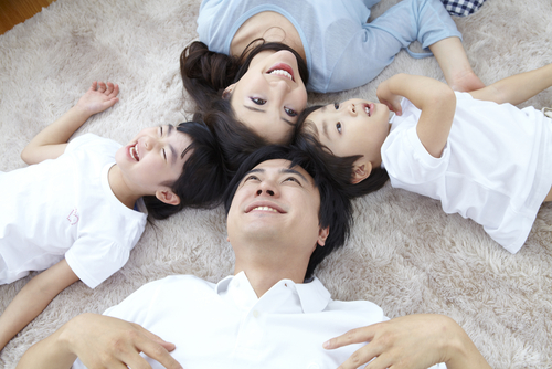 Happy family lying on clean rug
